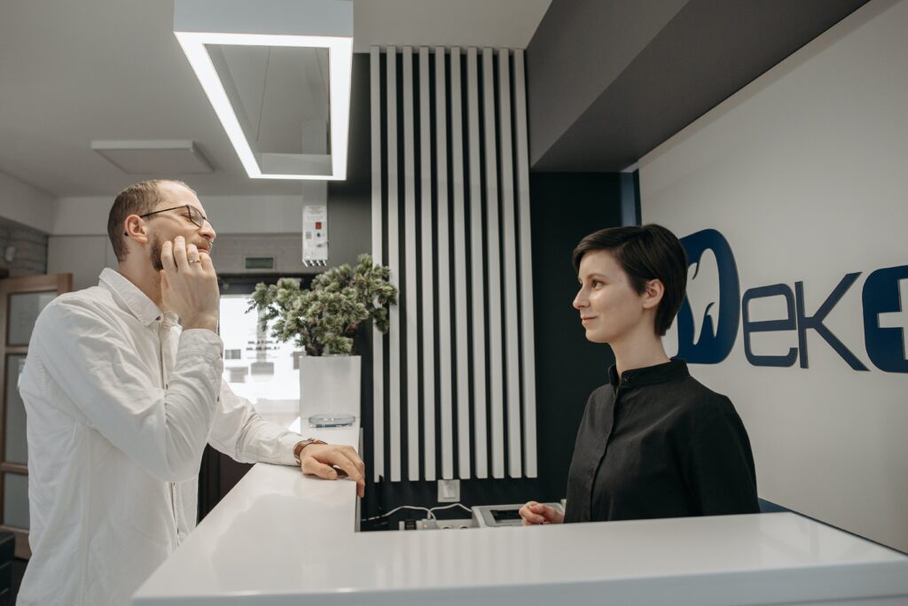 A women in a doctors offices providing medical answering services to patients calling to schedule appointments. 