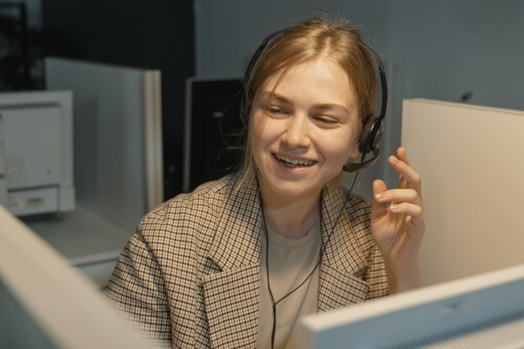 A woman working as a virtual receptionist takes customer service calls for a property management company.